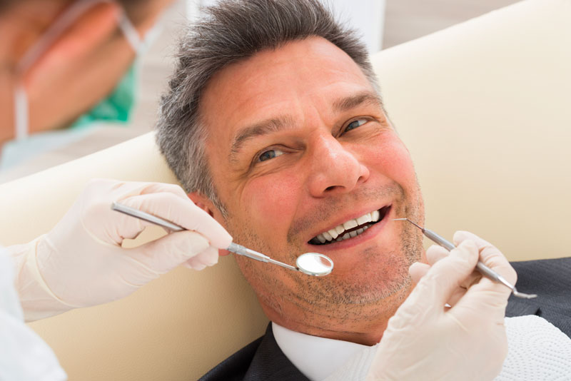 Dentist Treating Patient's Discolored Teeth